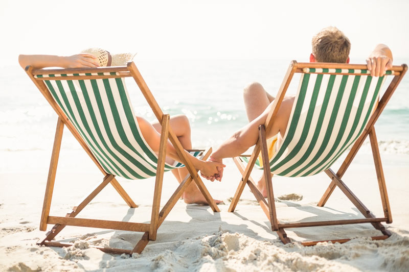 young people relaxing on branded beach chairs